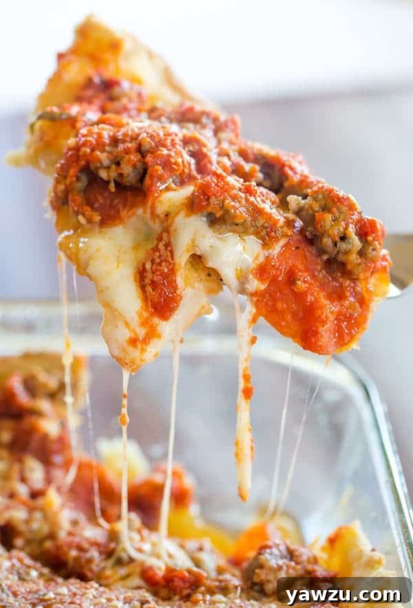 Delicious deep dish biscuit pizza with a golden, flaky crust, loaded with melted cheese, pepperoni, and sausage, fresh out of the oven.