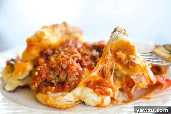 Two hands reaching for slices of freshly baked deep dish biscuit pizza, highlighting its comforting and shareable nature.