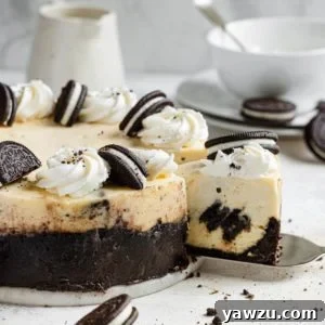 A freshly baked Oreo cheesecake with a single slice removed, garnished with whipped cream and crushed Oreos, symbolizing its rich flavor and texture.