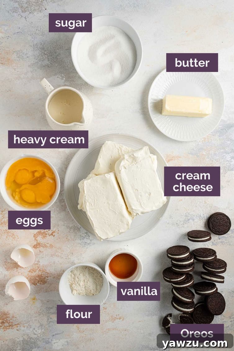 Various baking ingredients meticulously prepped and labeled on a kitchen counter, ready for making an Oreo cheesecake, including cream cheese, sugar, flour, eggs, and heavy cream.
