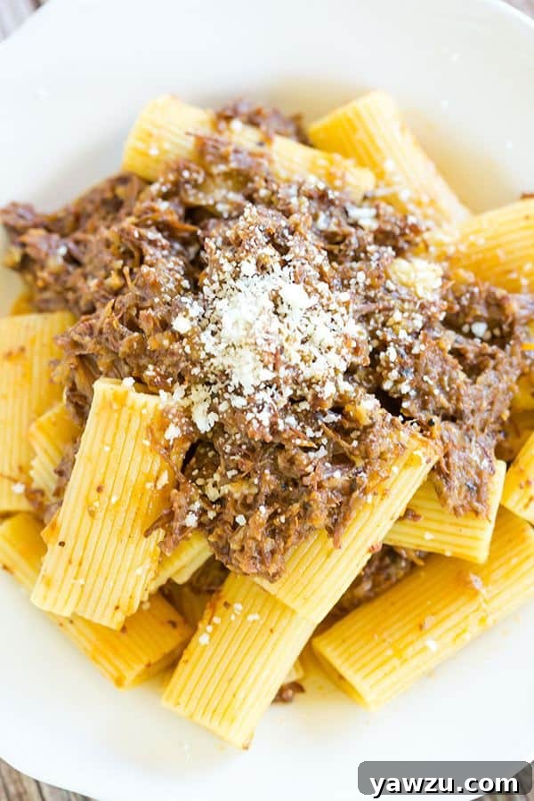 A serving of Pasta Genovese topped with grated Pecorino Romano cheese