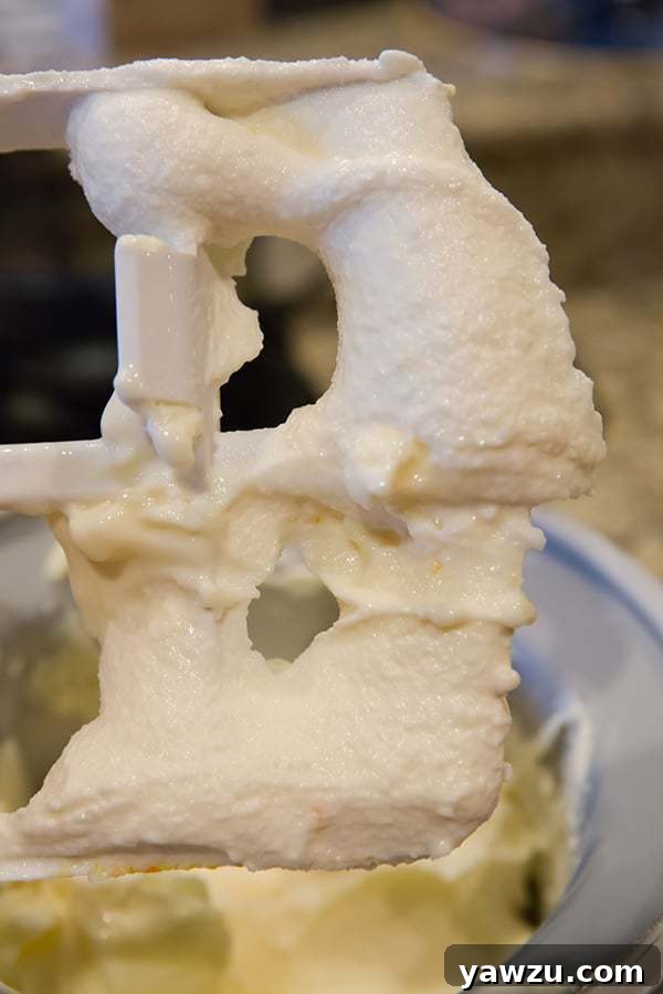 Orange Frozen Yogurt mixture being churned in an ice cream maker