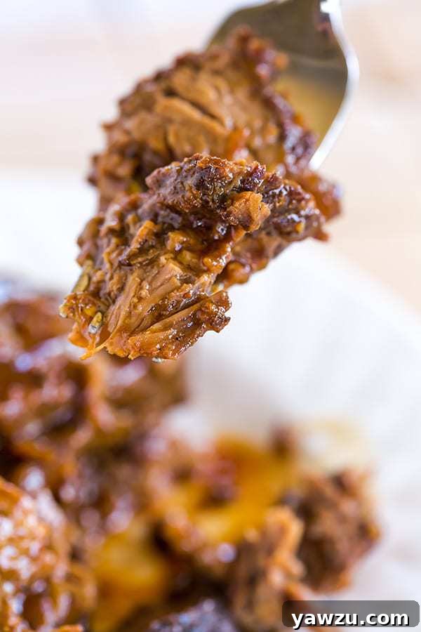 Sliced Slow Cooker BBQ Brisket ready to serve, showing tender texture.