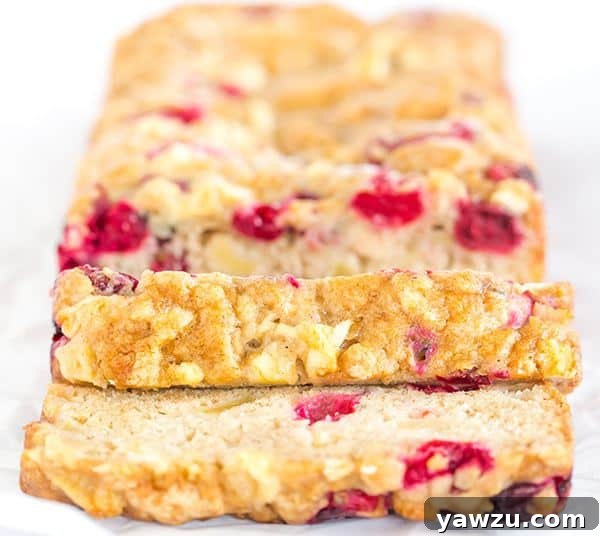 Delicious slices of Apple Cranberry Bread cooling on a wire rack, ready to be enjoyed.