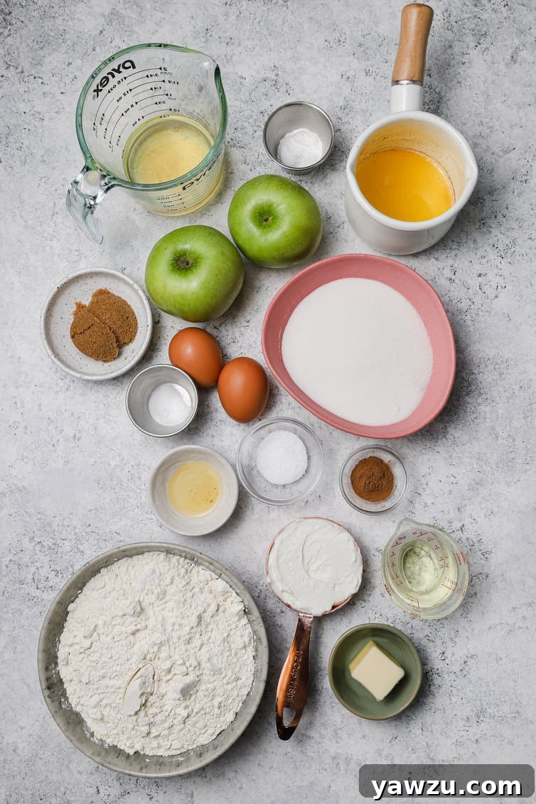 Ingredients for apple muffins prepped in bowls on counter.