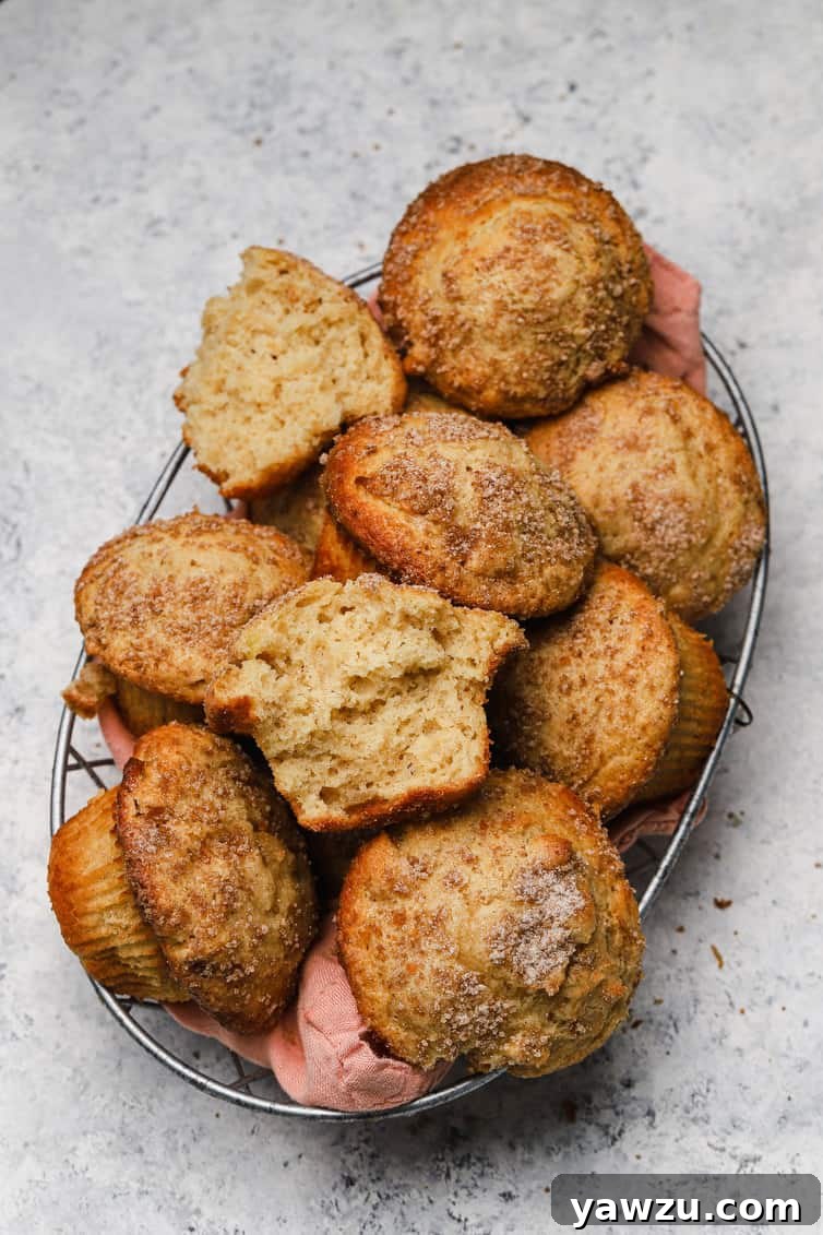 A basket of apple muffins with one split in half.