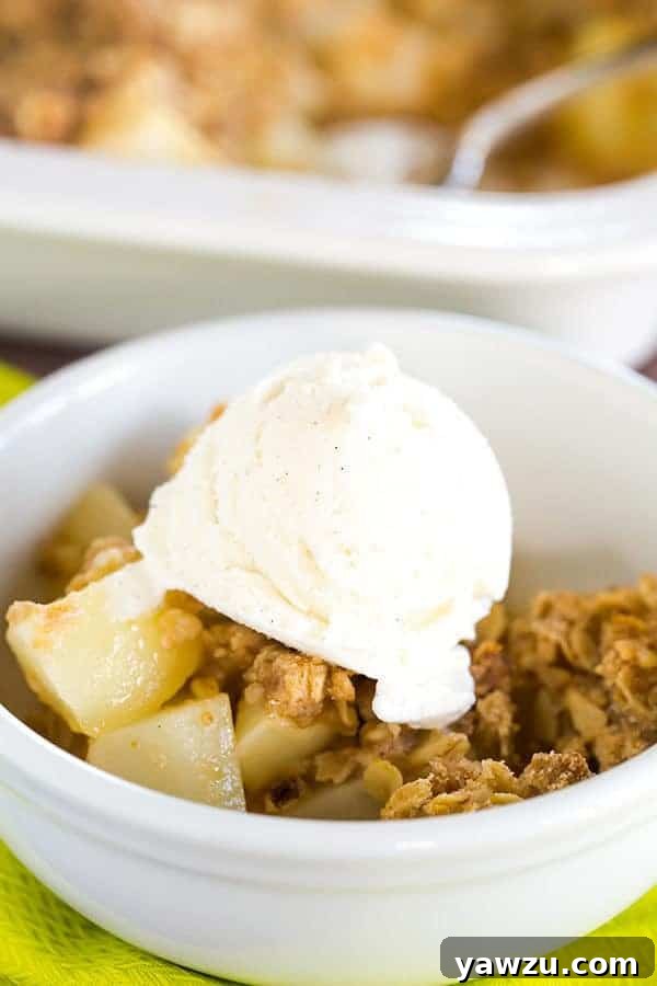 Perfectly baked pear crisp with golden oat topping, served warm in a dish, ideal for a cozy autumn evening