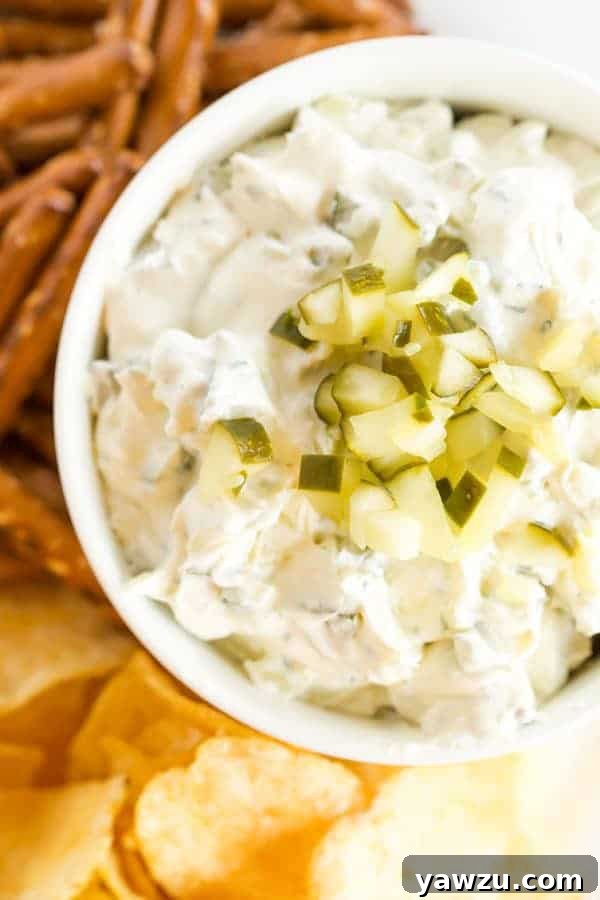 Creamy Dill Pickle Dip, perfect for parties, served with various dippers like pretzels, chips, and fresh vegetables.