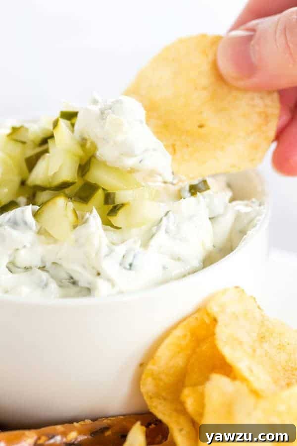 Dill Pickle Dip served with a variety of snacks, including pretzels, chips, and carrot sticks, ready for sharing.