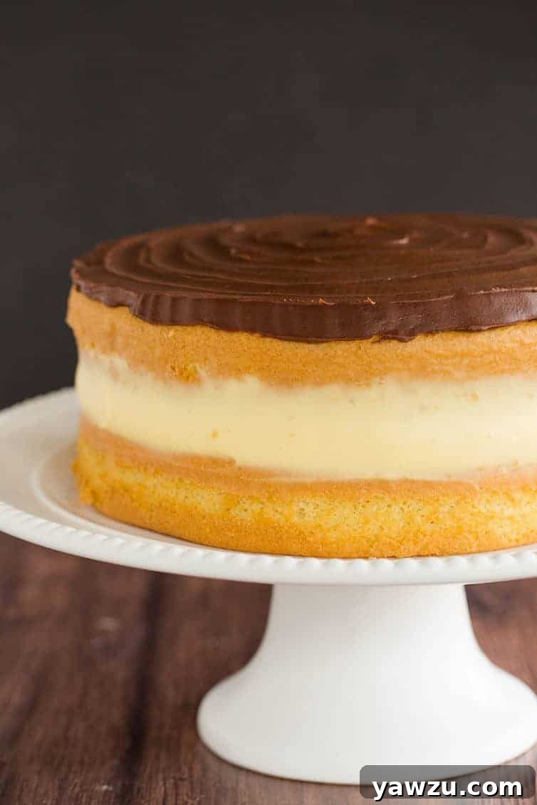 The Ultimate Homemade Boston Cream Pie with a perfectly baked vanilla cake, silky pastry cream, and glossy chocolate ganache.