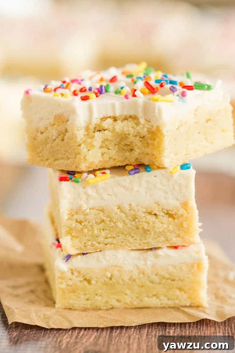 A tantalizing stack of sugar cookie bars, with the top bar showing a perfect bite taken out, inviting you to indulge.
