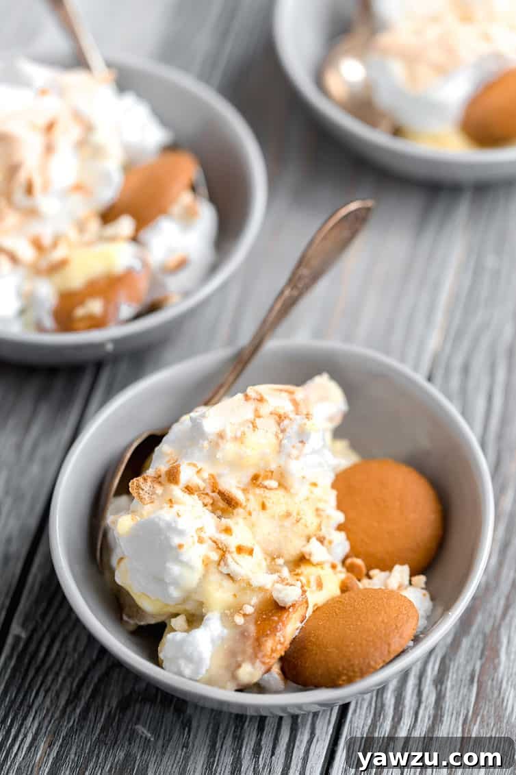 Three individual serving bowls of Southern banana pudding, each beautifully topped with golden-brown meringue, perfectly portioned for a cozy and satisfying dessert.