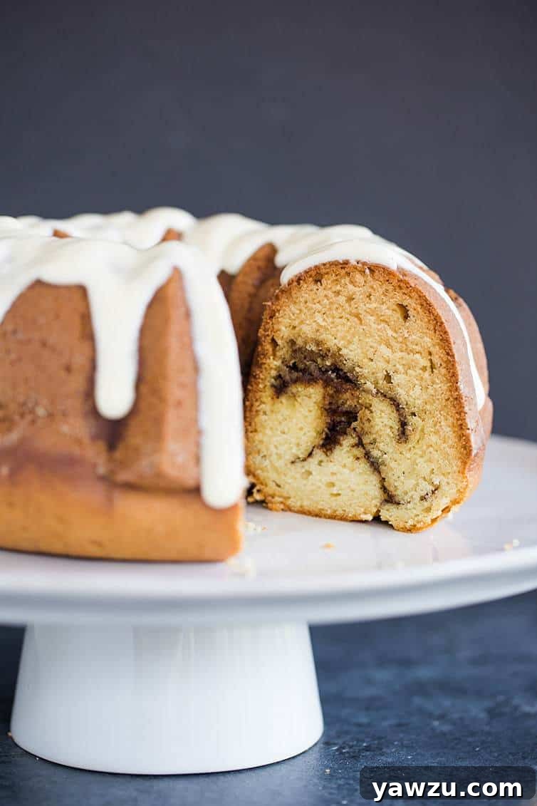 A beautiful bundt coffee cake with cinnamon swirls and cream cheese icing.