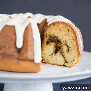 A beautiful bundt coffee cake with cinnamon swirls and cream cheese icing.