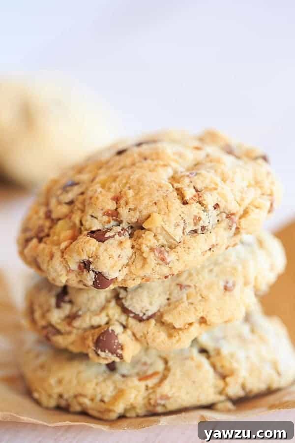 A batch of freshly baked Neiman Marcus cookies, featuring ground oats, rich chocolate chips, grated chocolate, and crunchy walnuts.