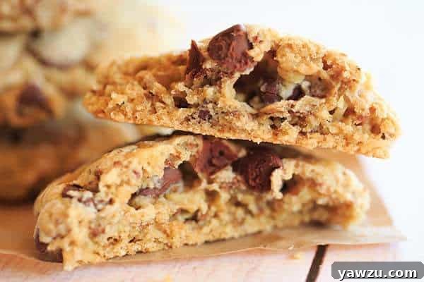 Stacked Neiman Marcus cookies, showing the chunky texture and rich mix of chocolate and walnuts.