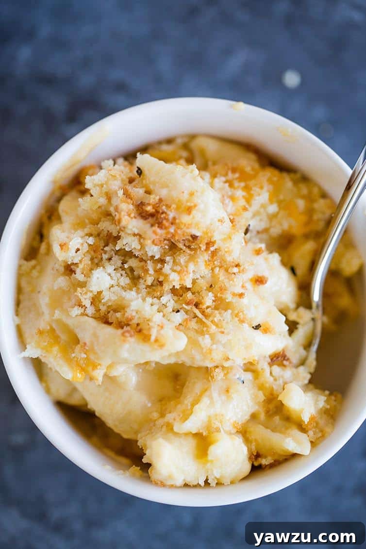 A large bowl of Chrissy Teigen's baked mac and cheese, showcasing its golden-brown topping and creamy interior.