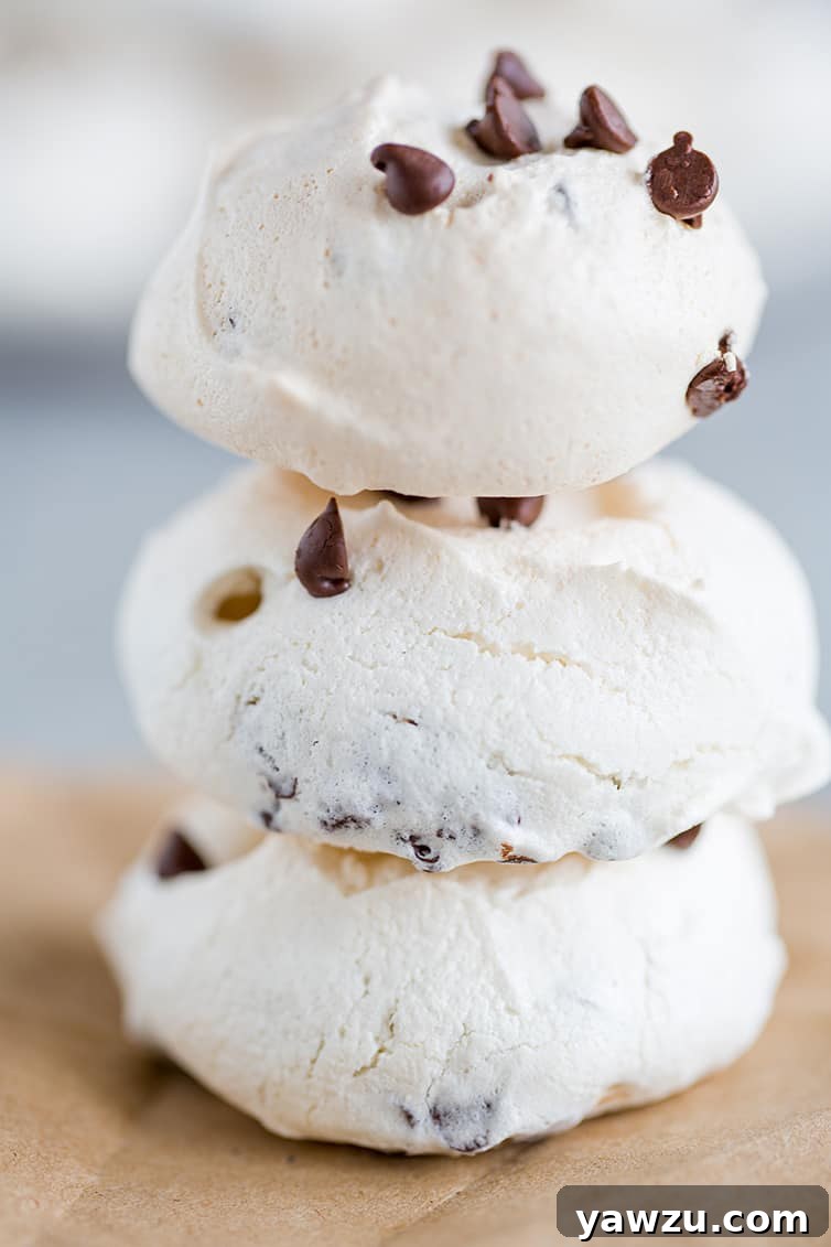 A beautifully arranged stack of golden chocolate chip meringue cookies, showcasing their delicate form.