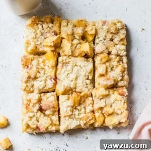 Peach crumb bars cut into nine squares.