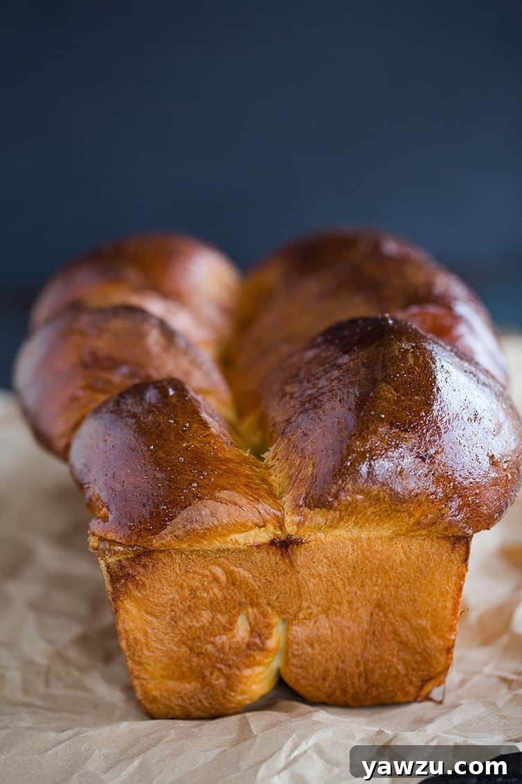 One loaf of milk bread on a piece of parchment paper.