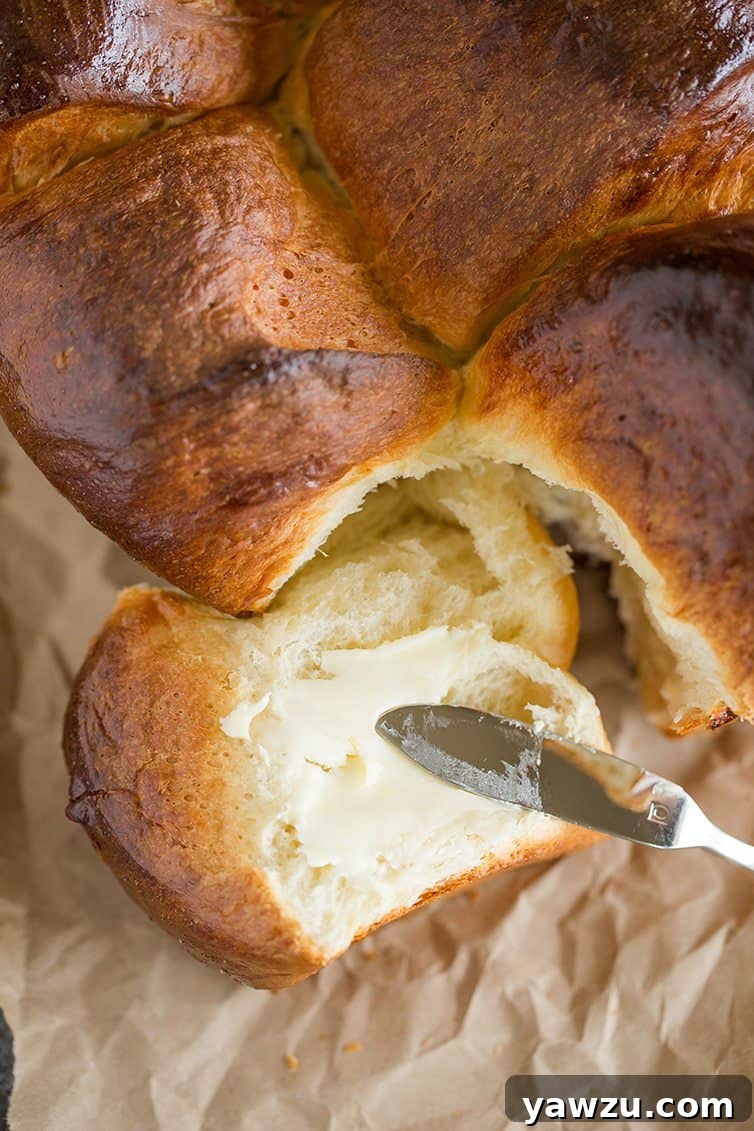 Pull-apart milk bread being spread with butter.