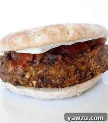 Black bean burger on a bun topped with ketchup and cheese.