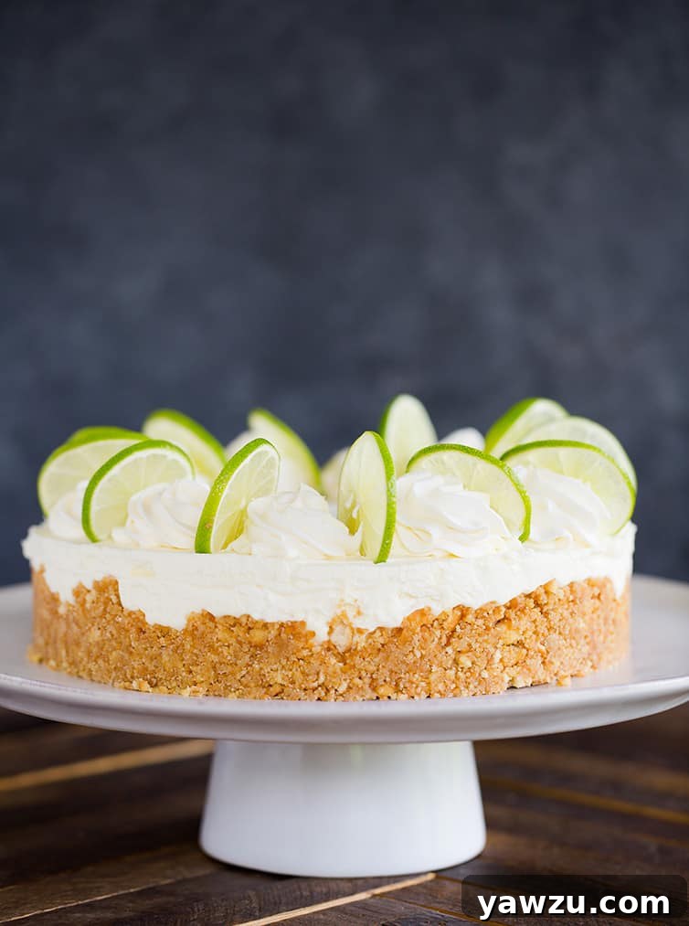 A key lime cheesecake on a serving platter.