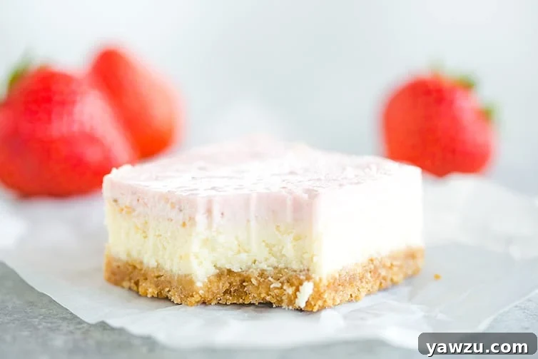 A single strawberry cheesecake bar with a bite taken out of it, revealing the layers of crust, cheesecake, and strawberry topping.