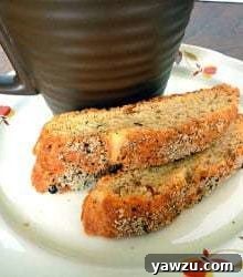 Two pieces of Parmesan black pepper biscotti on a white plate.