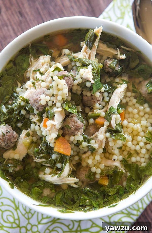 A classic Italian wedding soup with mini meatballs, shredded chicken, and spinach