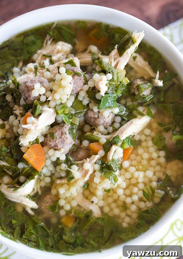 Close-up of Italian wedding soup in a bowl with a spoon