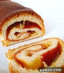 Swirled cheese and pepperoni bread with a slice cut showing the inside, highlighting the delicious texture and filling.