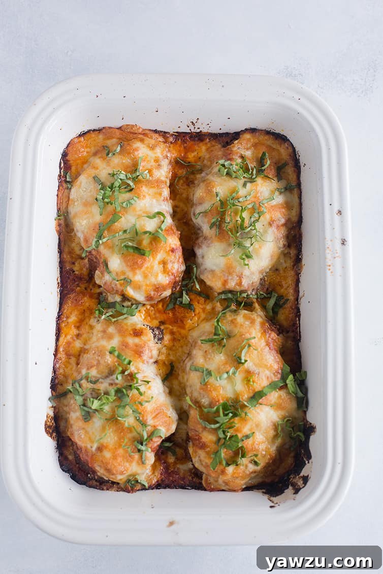 A baking pan filled with perfectly baked chicken parmesan, featuring a golden, bubbly cheese topping.