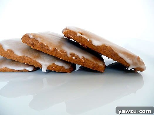 4 glazed lebkuchen cookies on a white plate.