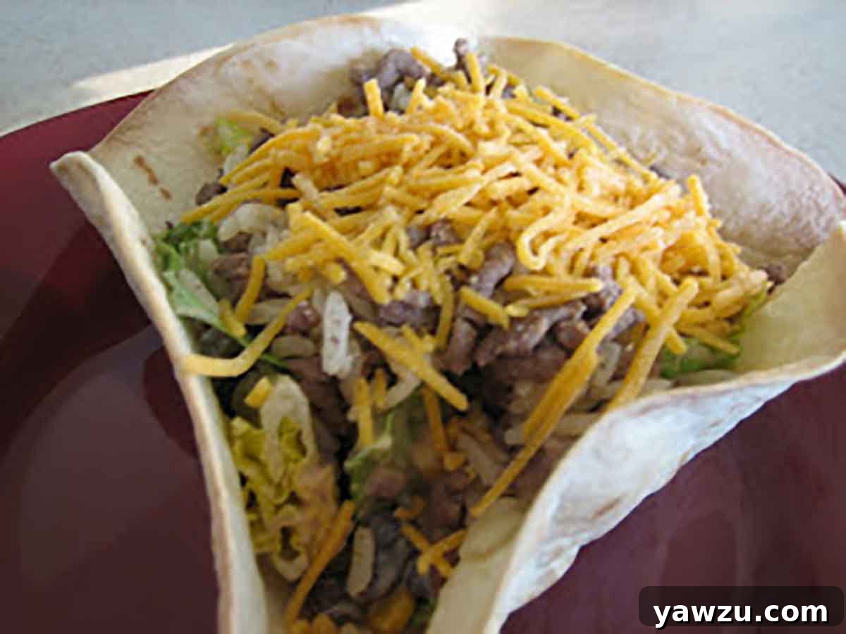 Homemade tortilla bowl filled with vibrant taco rice salad.