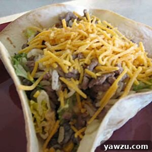 Taco rice salad in a homemade tortilla bowl, close-up shot.
