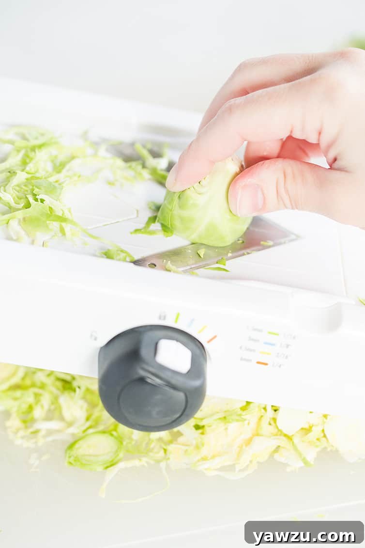 Slicing Brussels sprouts on a mandoline.
