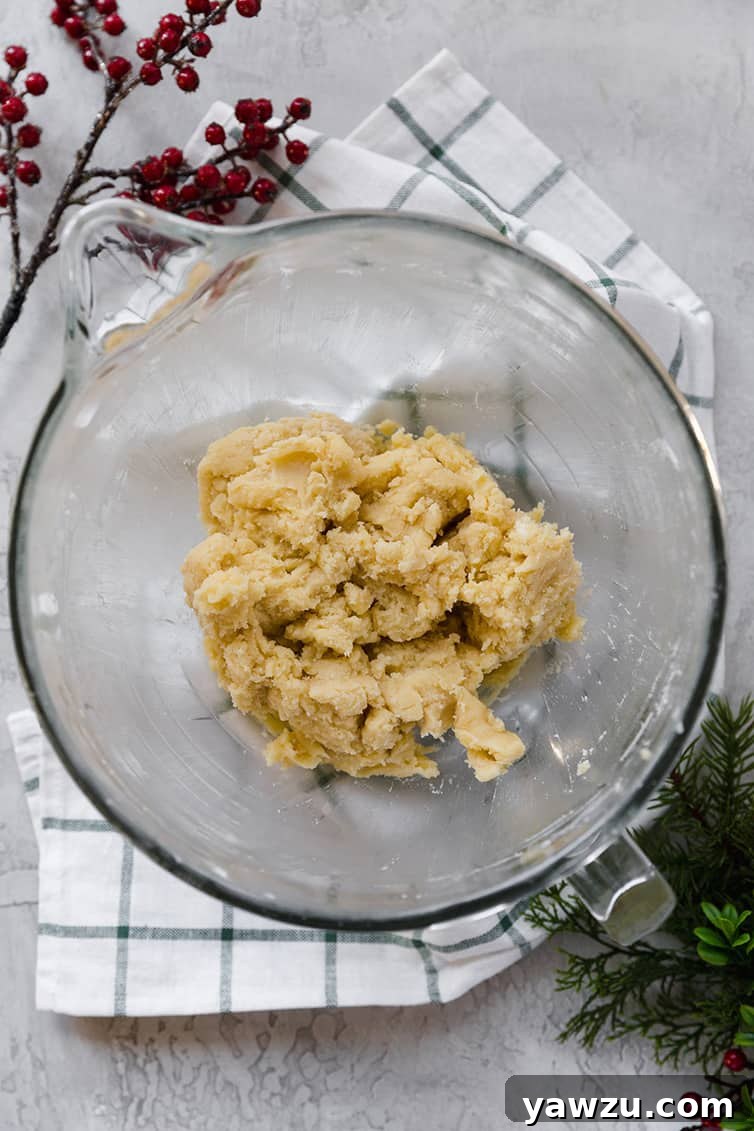 A glass mixing bowl with the dough for Danish butter cookies.
