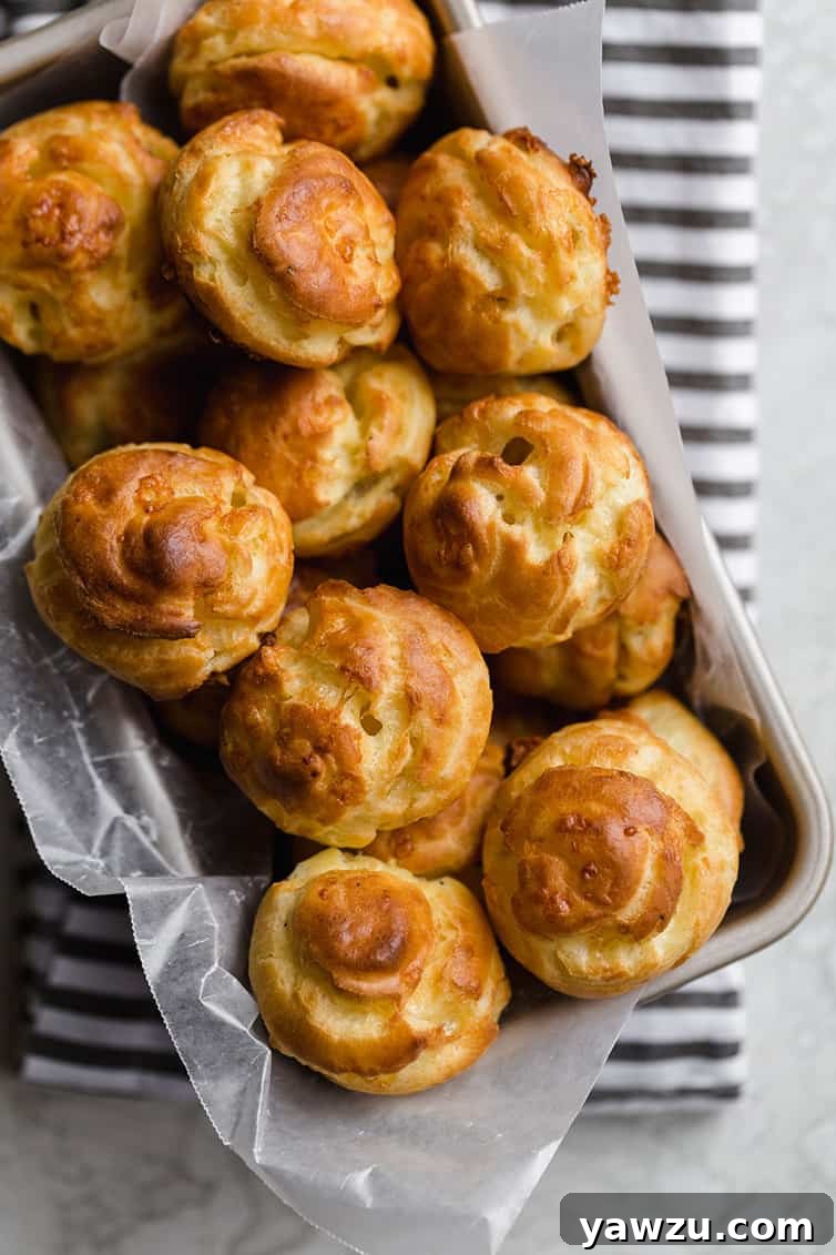 A charming wicker basket overflowing with freshly baked Gougères, ready to be served at a gathering.