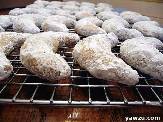 Freshly baked Nut Crescent Cookies lined up on a cooling rack, showing their perfect golden edges.
