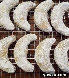 Overhead image of nut crescent cookies on a cooling rack.