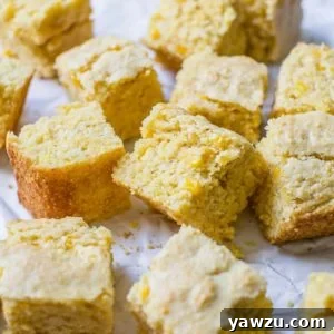 Squares of cornbread on a piece of parchment paper.