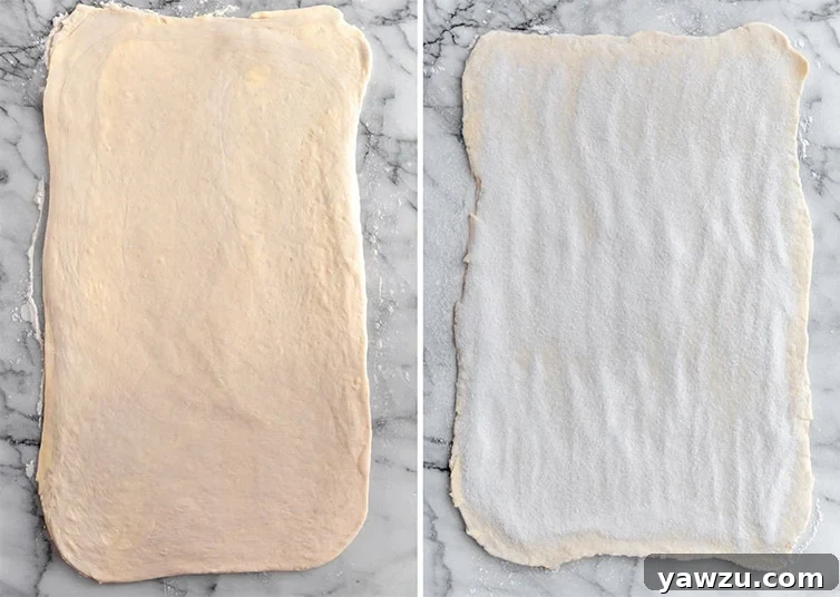 Kouign-Amann dough, precisely rolled out and generously sprinkled with granulated sugar, ready for the next fold.