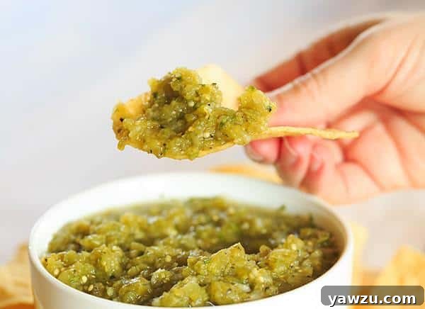 A bowl of vibrant green Salsa Verde, made with tomatillos and fresh Hatch chiles, offering a refreshing and zesty flavor.