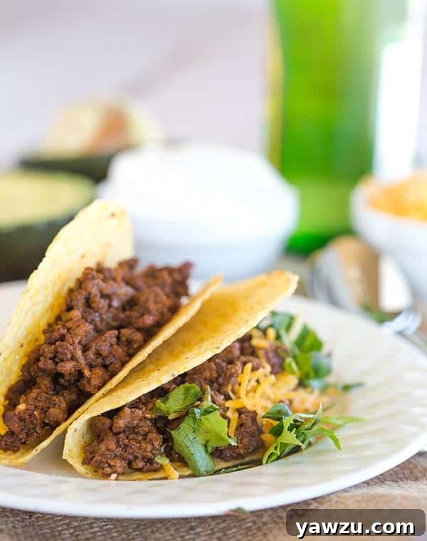 Deliciously seasoned ground beef tacos with fresh toppings, ready to be enjoyed.