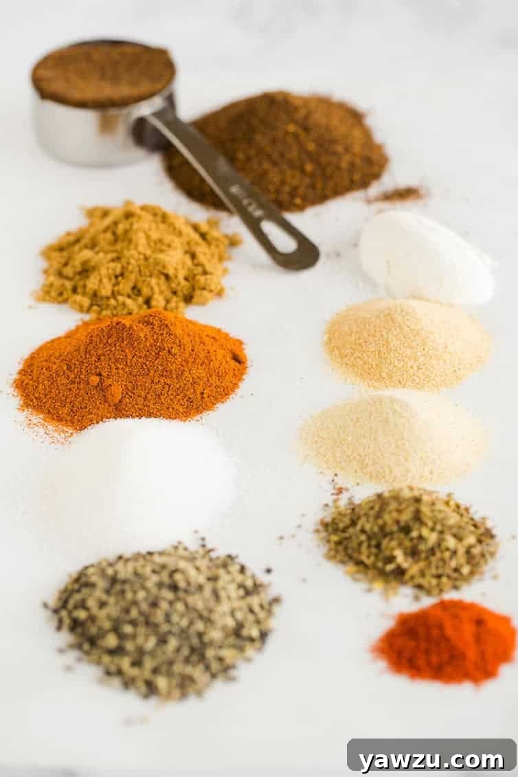 An array of fresh spices, neatly lined up and ready to be blended into homemade taco seasoning.