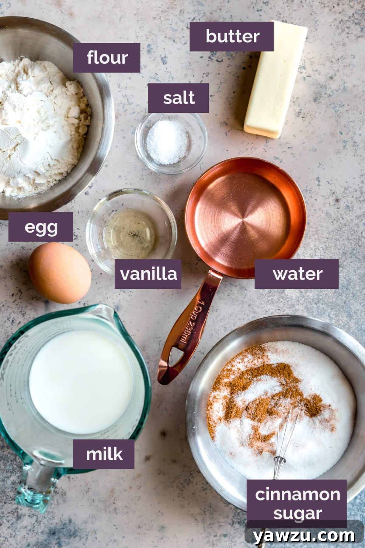 Ingredients for churros on a grey white counter with purple labels describing the ingredients. 