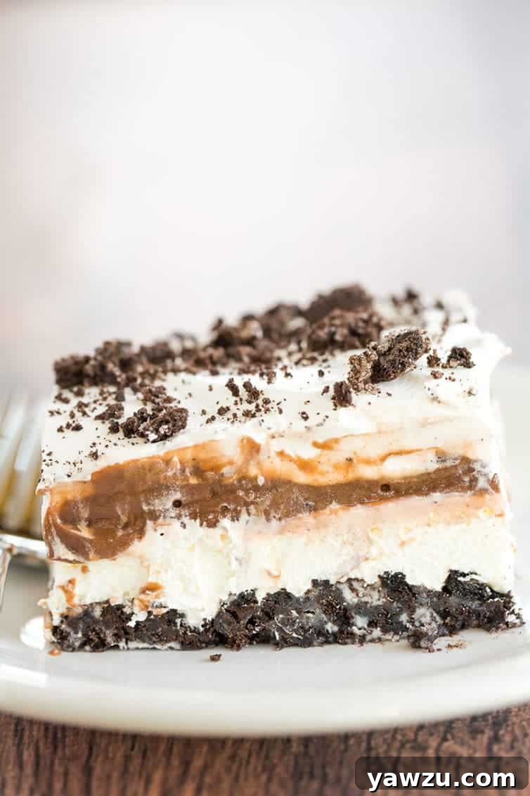 A generous slice of No Bake Oreo Layer Dessert, showcasing its distinct, delicious layers.