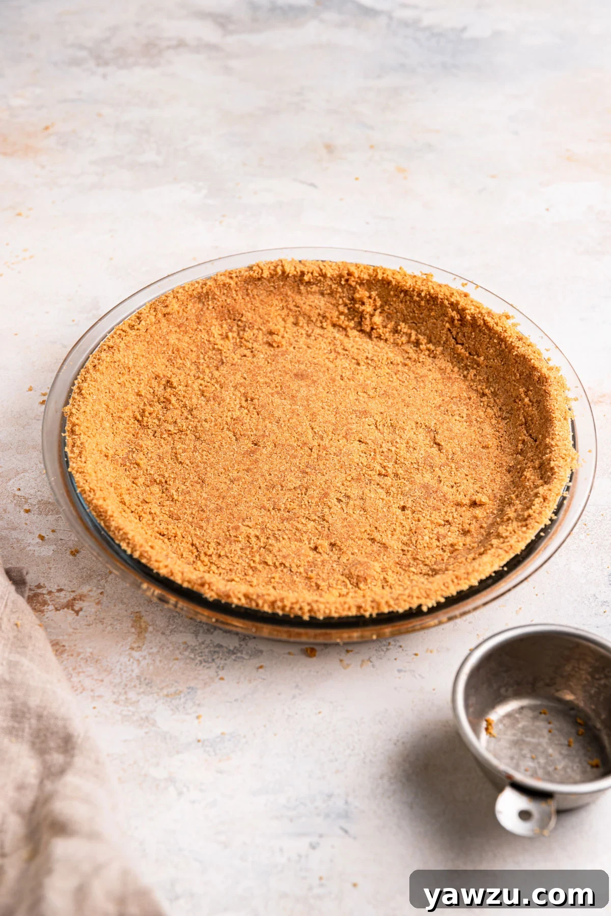 Graham cracker crust pressed into a glass pie plate.