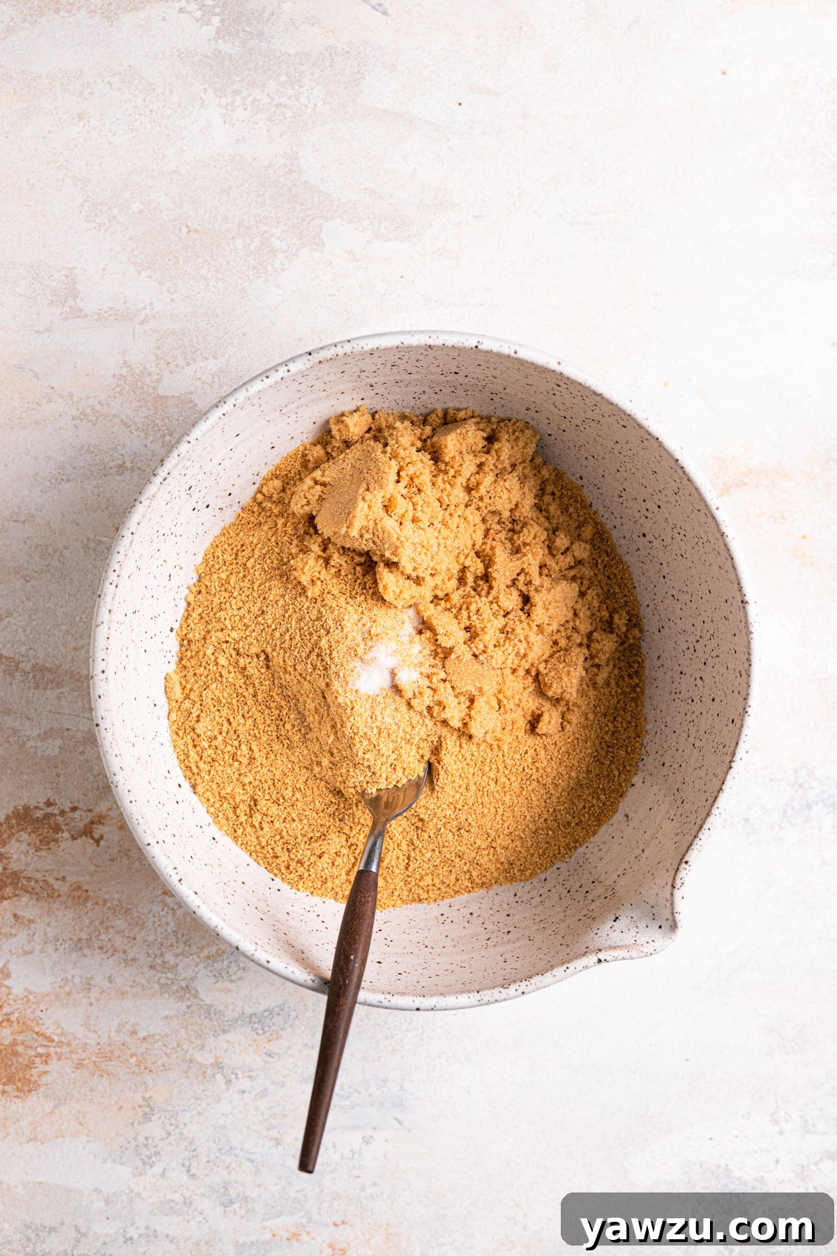 Graham cracker crumbs, brown sugar, and salt in a mixing bowl.